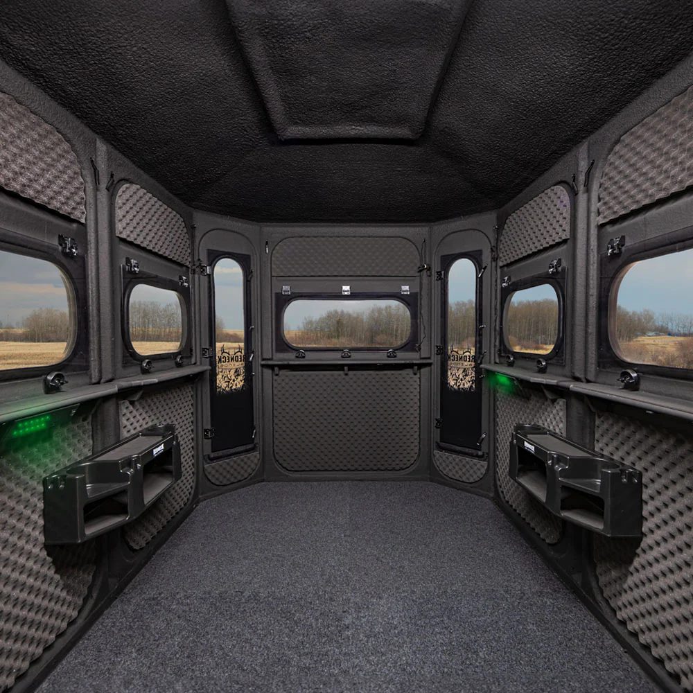 Interior view of Game Changer 6×8 fiberglass hunting blind with padded walls, insulated ceiling, and panoramic shooting windows
