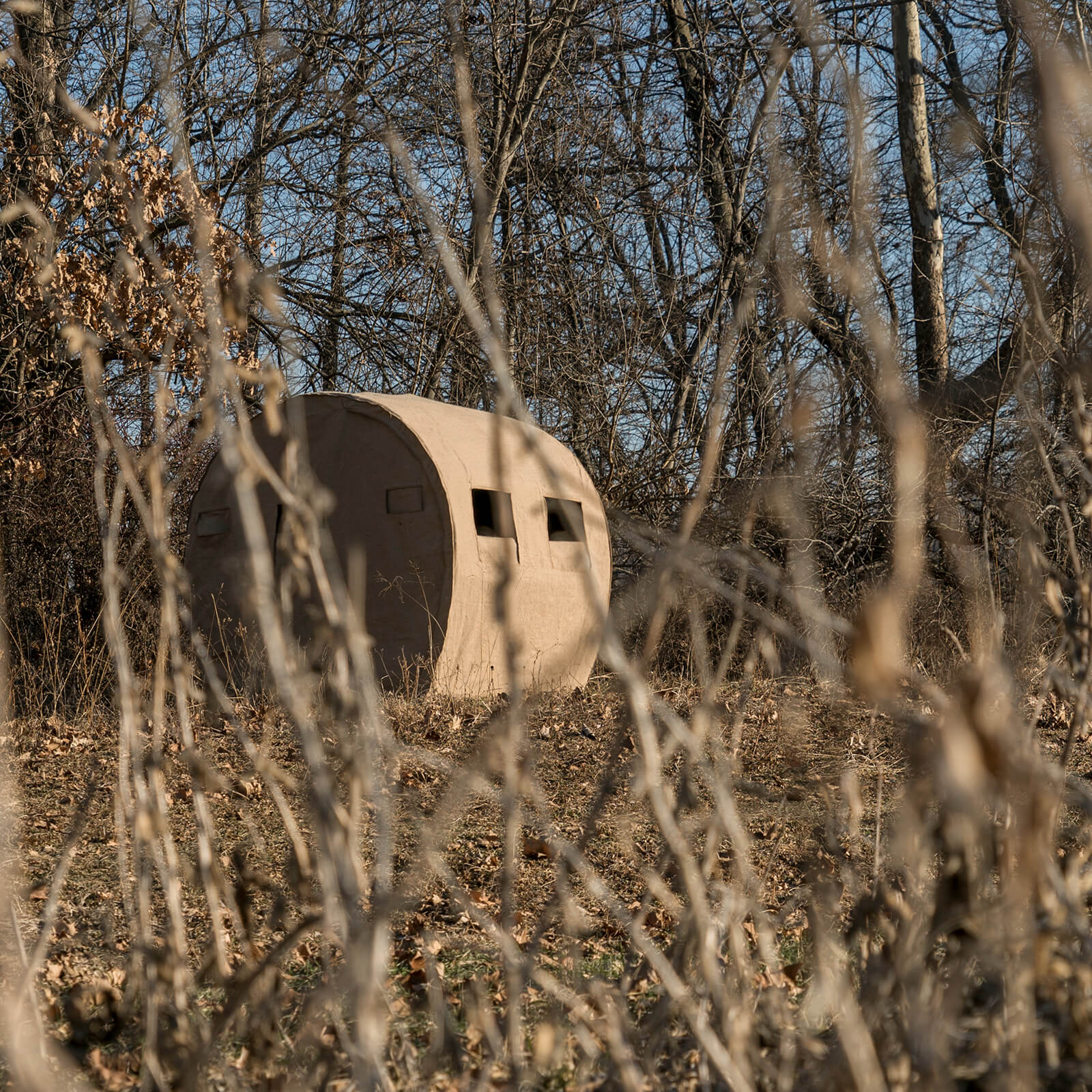 Outfitter Burlap Bale hunting blind blending naturally into fields and agricultural landscapes