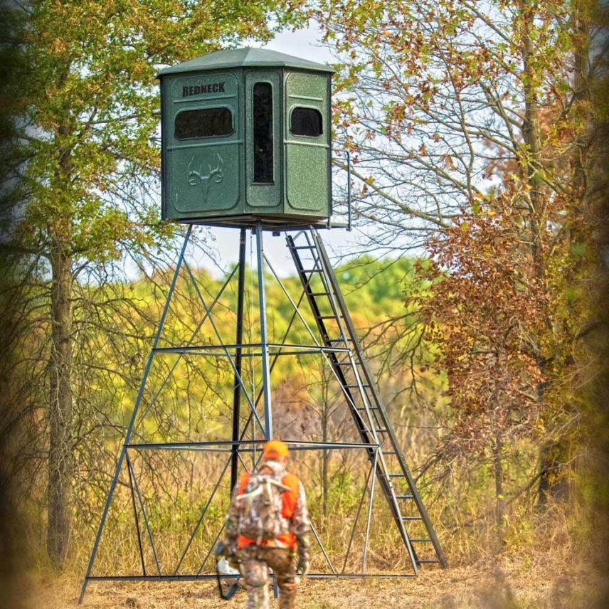 Elevated hunting blind with hunter approaching – Redneck box blind for deer hunting in Kentucky woods