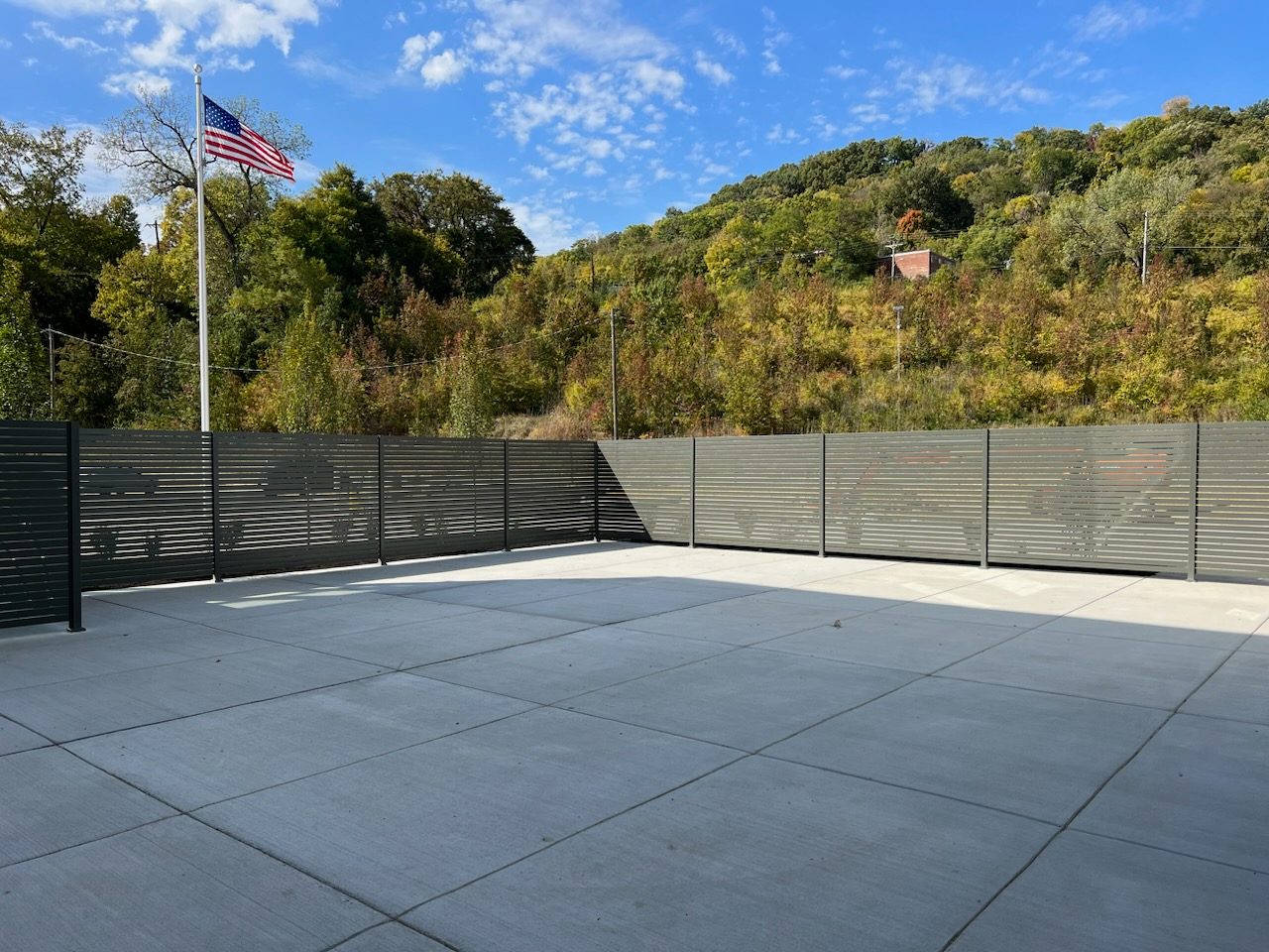 Modern metal slat privacy fence around patio, clean lines that support curb appeal improvements.