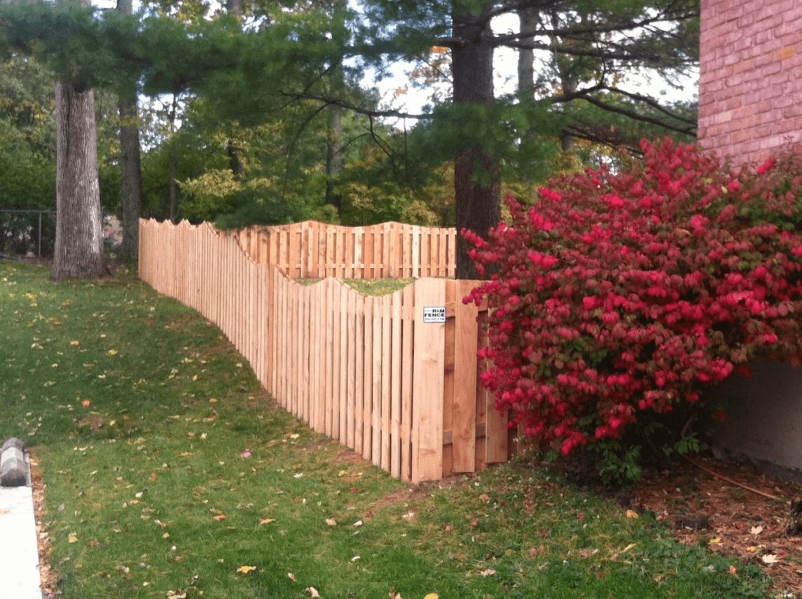 Wood picket privacy fence screening a property edge