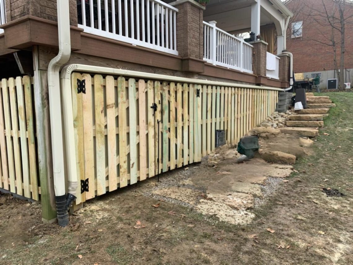 Wood privacy fence along a side yard, a clean backyard privacy upgrade that can support home value.