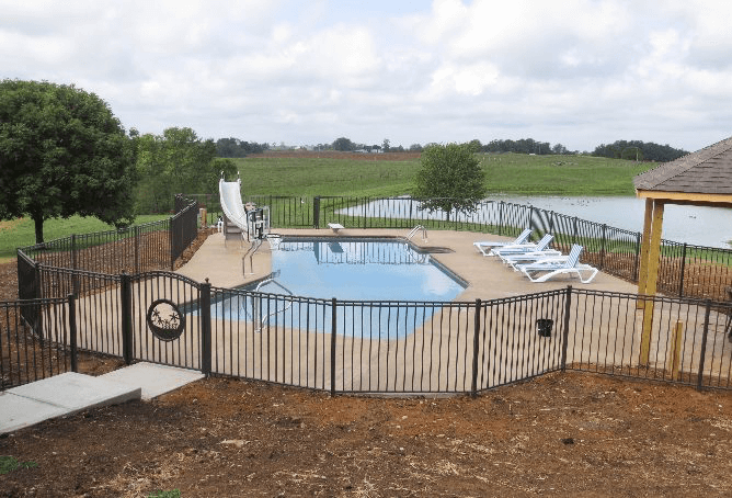 Decorative metal fence enclosing a backyard pool to meet Kentucky pool barrier requirements