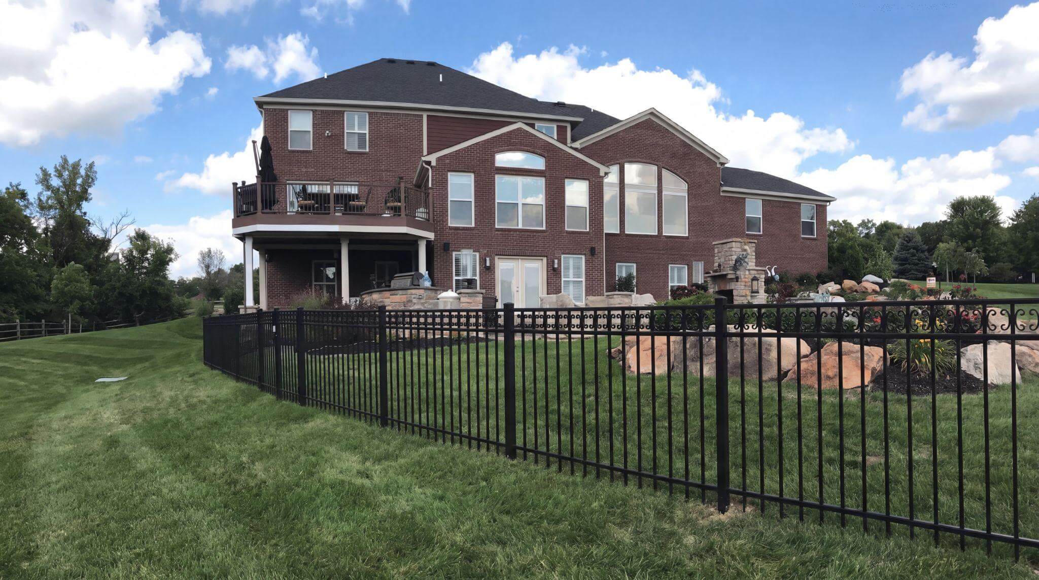 Black aluminum pet safe fence around a Northern Kentucky backyard with vertical bars that dogs cannot grip
