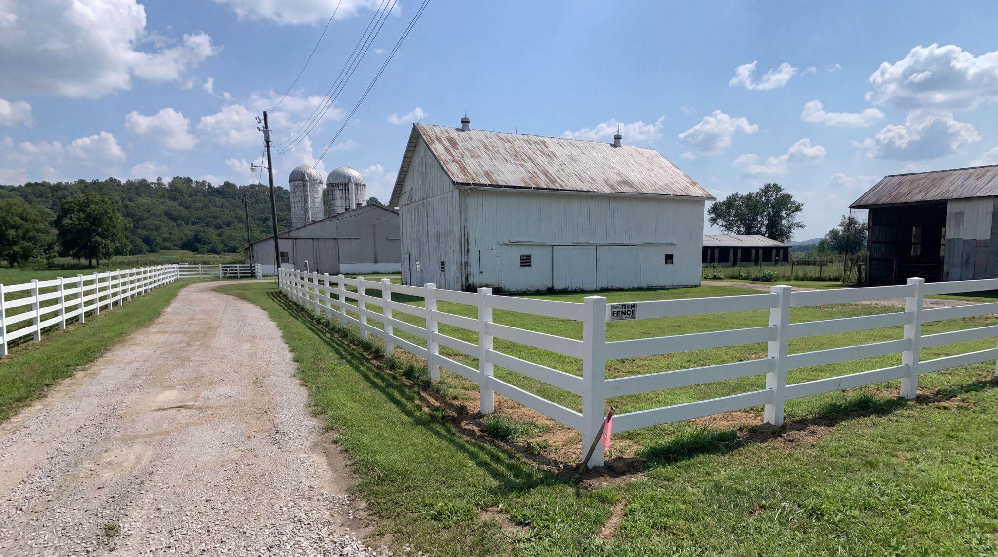 White Kentucky board fence lining a rural farm driveway in Northern Kentucky
